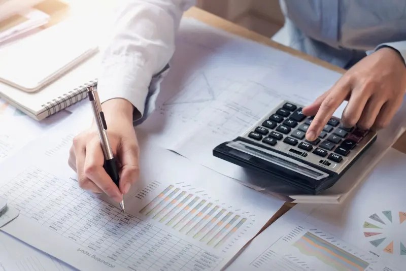 Person using a calculator for financial analysis